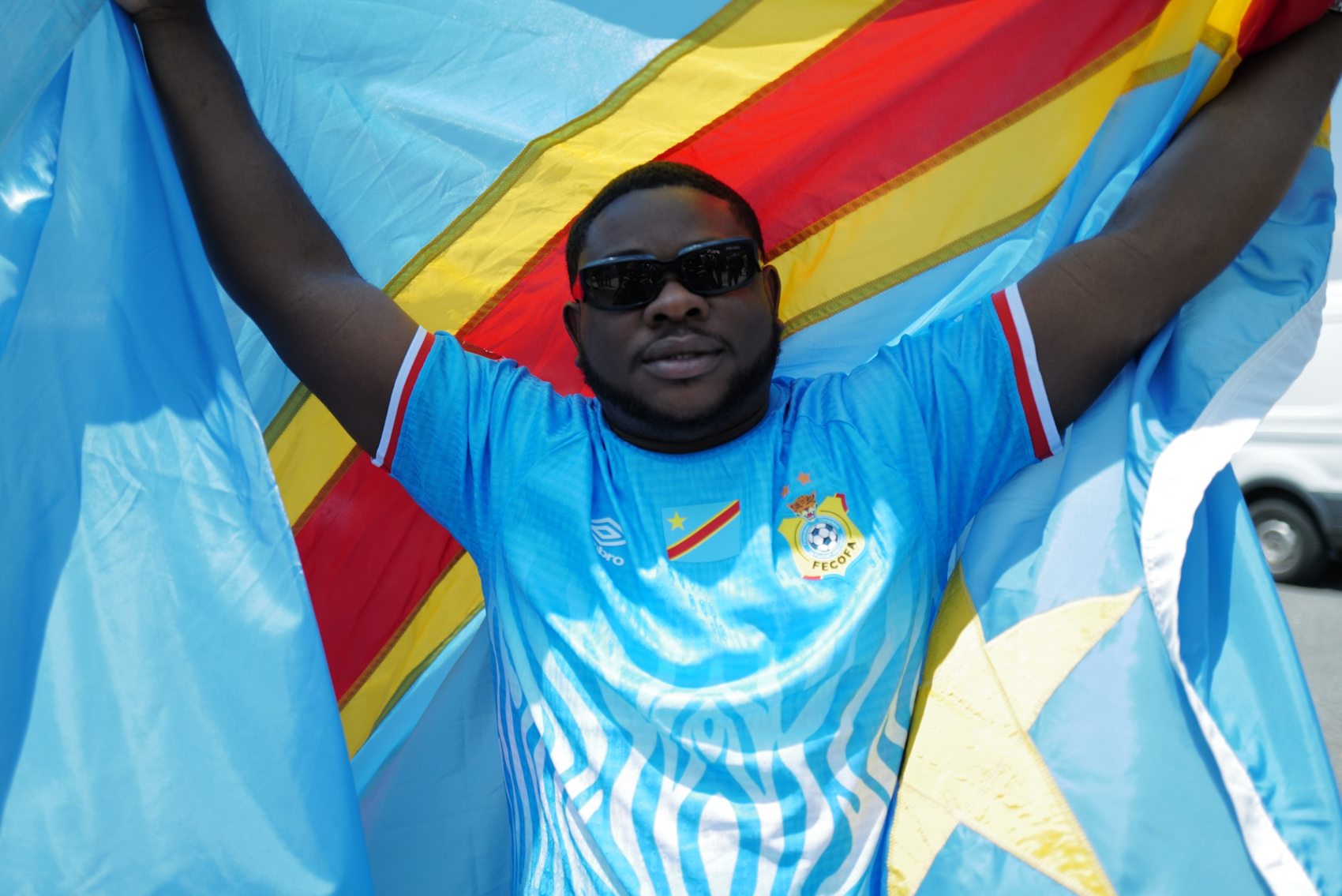 A Congolese supporter holding the DRC flag outside the stadium