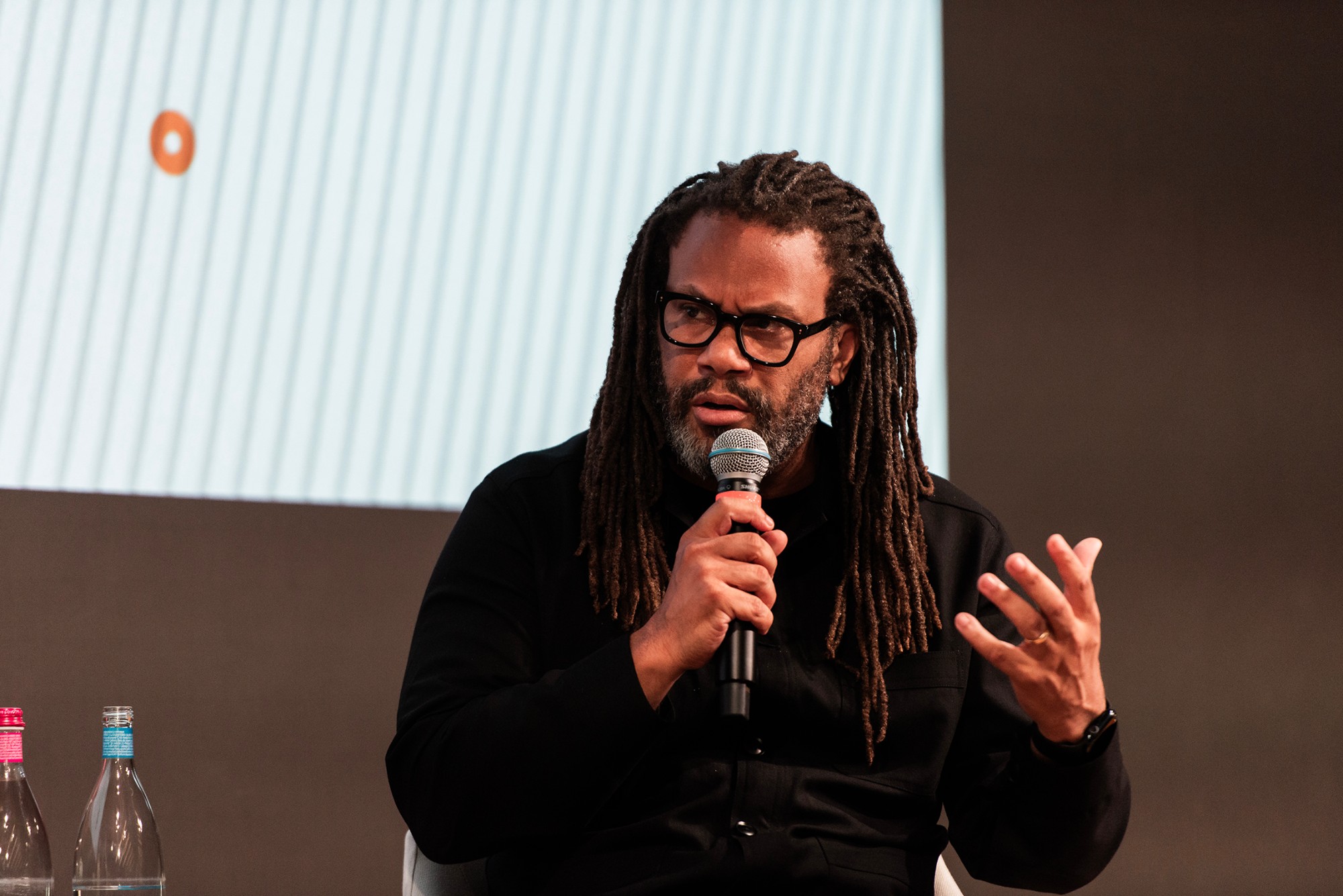 Franklin Leonard speaking on a panel, microphone in hand, mid-sentence